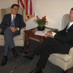 Presidential candidate Mitt Romney sits with Ray Collins in Sarasota.