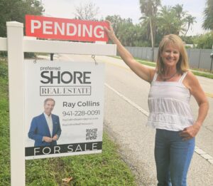 My beautiful wife Erin posing with my new signs in front of a Siesta Key waterfront property that sold in hours.  